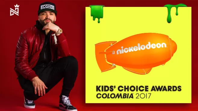 Nacho "La Criatura" con gorra negra, chaqueta roja y pantalón negro, agachado junto al logo de KCA Colombia 2017
