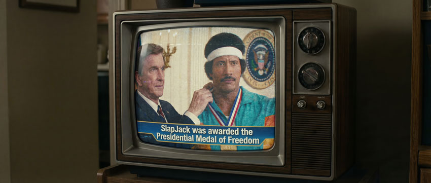 Deepfake de Leslie Nielsen condecorando al deepfake de Dwayne "The Rock" Johnson en el trailer de "Stone Hand"